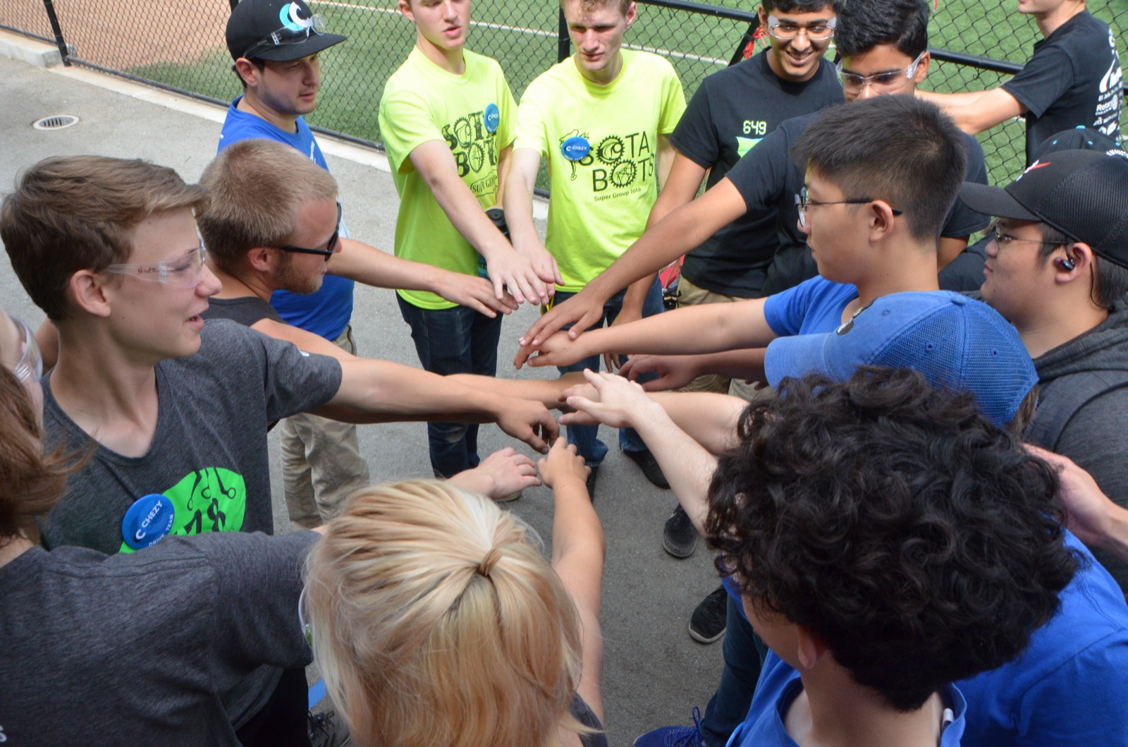 Students gathering in a team huddle during Chezy Champs 2018